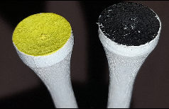 Photograph of yellow and black golf-tees